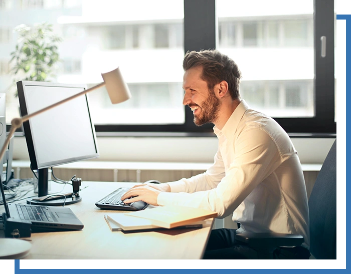 A man sitting at his desk with a computer.